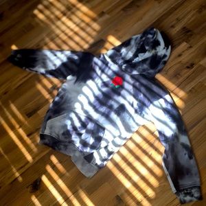 A sweater with a rose in the middle no stand or anything